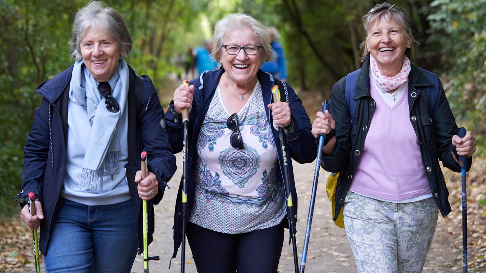 3 Frauen beim Nordic Walken im Wald