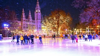 People skating on the ice rink in front of Vienna City Hall