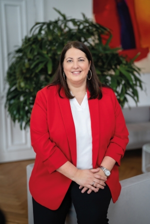 Formal Portrait of Deputy Mayor Kathrin Gaál: She is wearing a red blazer over a white blouse and has shoulder-length brown hair. There is a plant in the background.