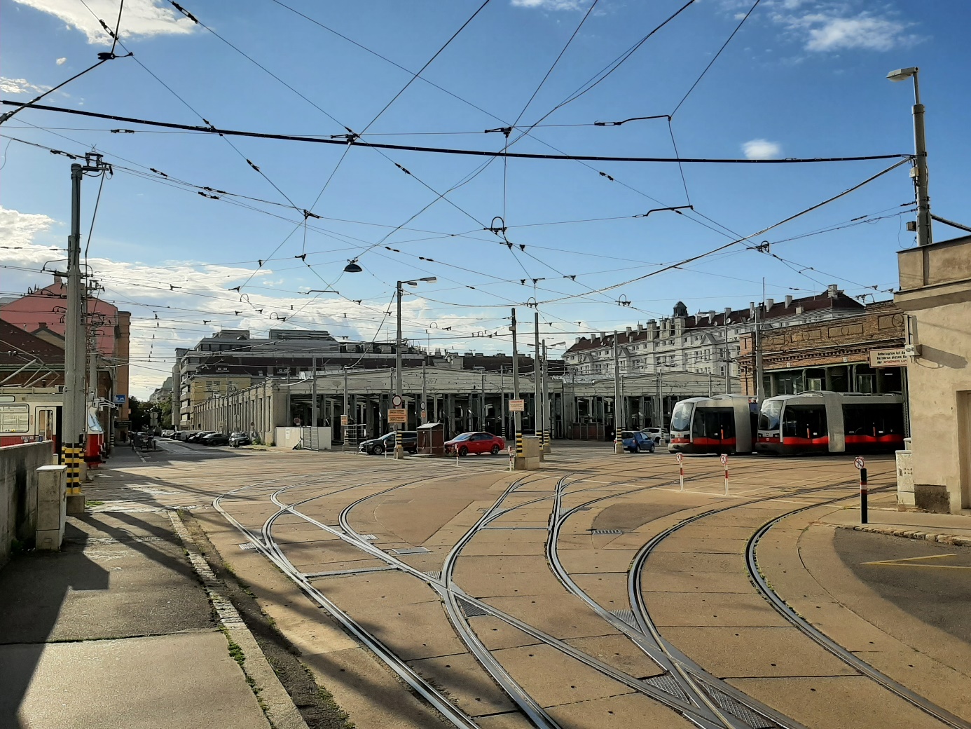 Favoriten tram depot

Premises of the Favoriten tram depot, with tracks that spread like the branches of a tree in the foreground; several trams are shown at the centre, parked in the roofed-over depot buildings. 