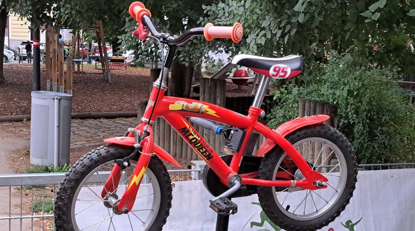 Bike repair point in Arthaberpark

A red kid's bike with lettering "McQueen" on a bike stand in the park