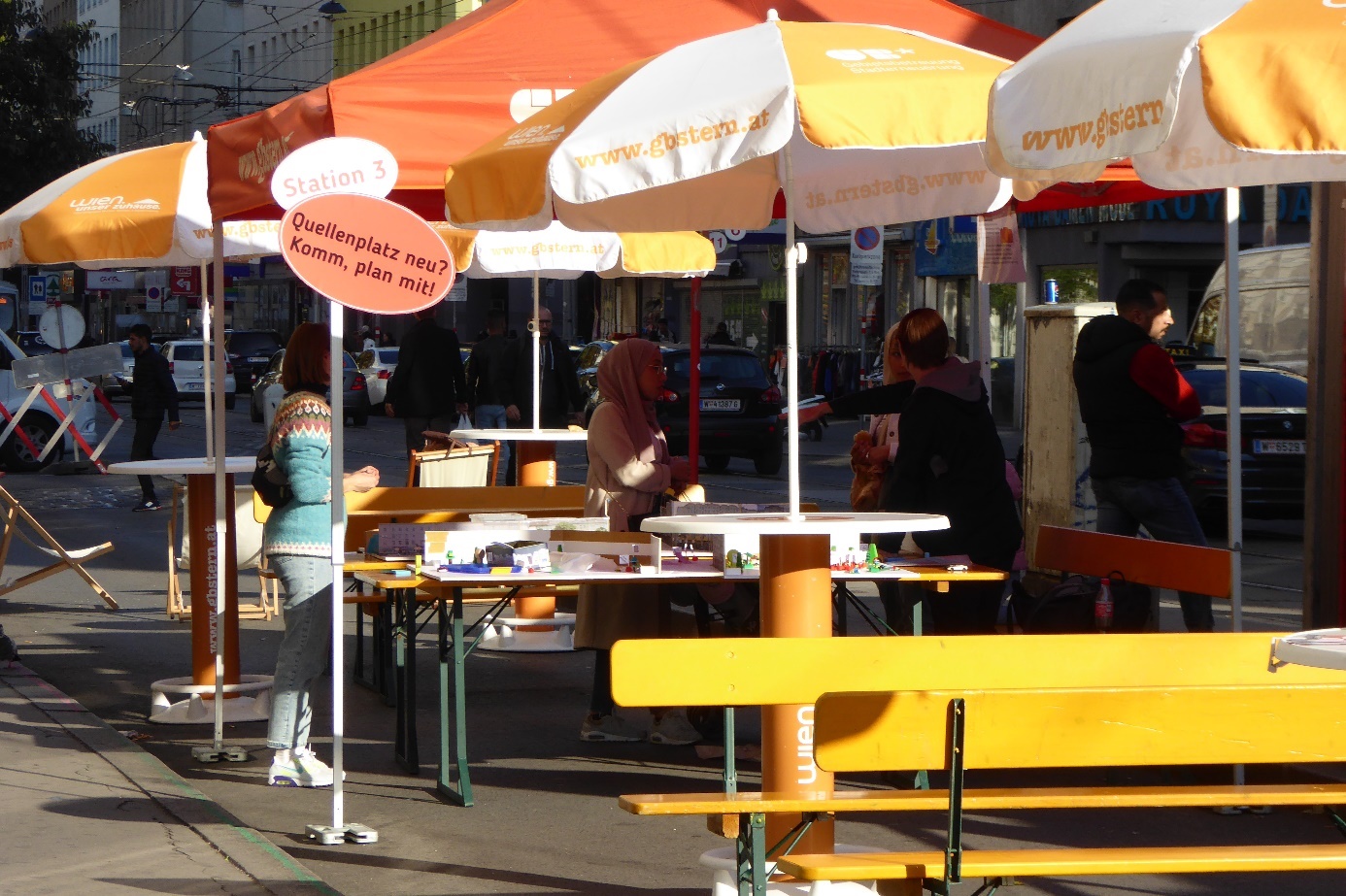 Information tables in Quellenplatz square

Information tables with colourful sunshades and visitors 